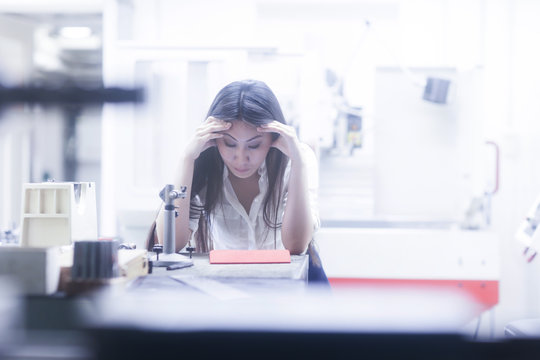 Female engineer looking at technical drawings on a digital tablet