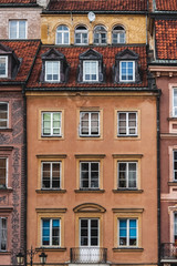 Fototapeta na wymiar old beautiful town houses; Sights of Warsaw;colorful houses with windows;
