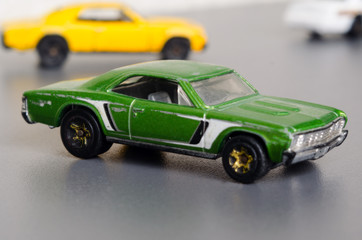 Green car. Side view on a gray background.