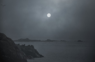 Foggy full moon in the sea