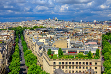 Fototapeta premium Paris skyline aerial view panorama from top of Arc de Triomphe. Distant Sacre-Coeur church of Paris or Sacred Heart Basilica Landmark in Paris, France, Europe.