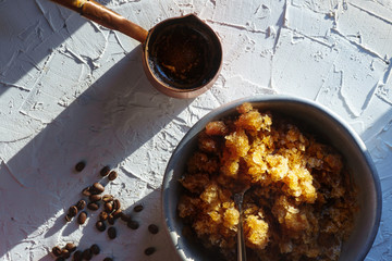 Bowl with coffee cold dessert on the table and a coffee maker
