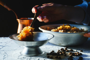 Bowl with a cold coffee dessert, a dish for dessert and a grain on the table close-up. Sicilian granite