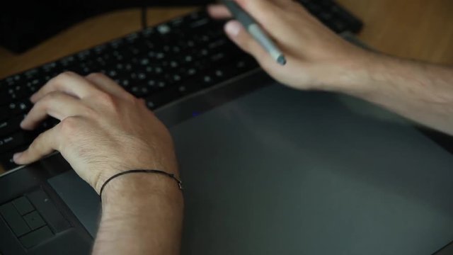 man working on computer with Drawing tablet. close-up