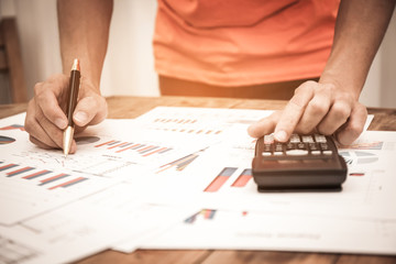 Businessman pen pointing graph chart for analyzing investment in his office