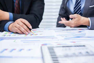 Business team financial inspector and secretary making report,tax,calculating or checking balance, Audit concept at working with plan and analyzing investment charts at workplace.