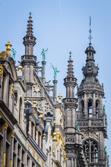 Fototapeta na wymiar Brussels, Belgium - May 14, 2018 - Statues and decorations of the roof of Town hall on the Grand place,