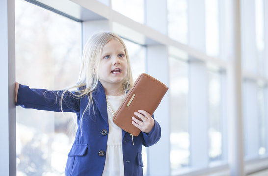 Portrait Of Displeased Bossy Little Girl In Office Building