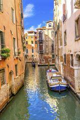 Fototapeta na wymiar Gondola Touirists Colorful Small Side Canal Bridge Venice Italy