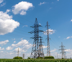 Electric towers on a blue cloudy sky background