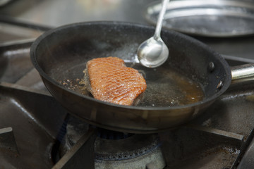 The cook fry the duck fillet in a frying pan. Gas hob