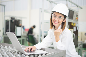 Female Engineer Working On Machine In Factory