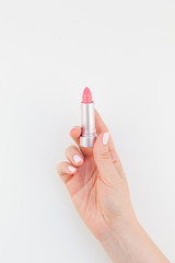 Woman hand with pink lipstick