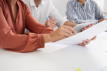 Woman holds a document in her hand as points