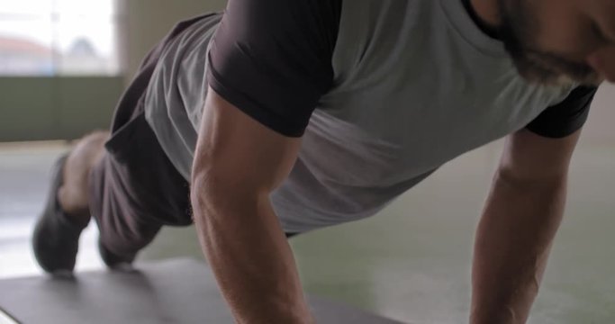 Young adult man doing push ups exercise during fitness sport workout .Grunge industrial urban training.4k slow motion video