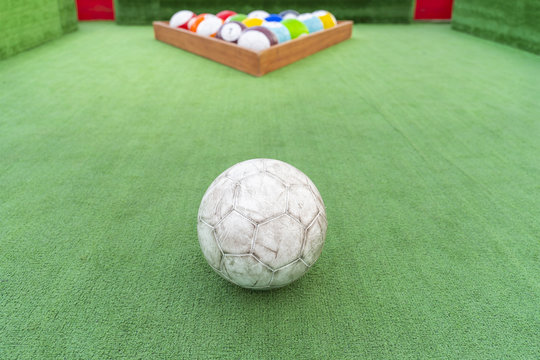 Ground pool snookball game with football balls on green grass reaching goal