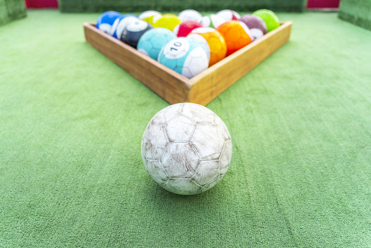Ground pool snookball game with football balls on green grass reaching goal