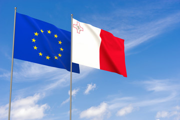European Union and Malta flags over blue sky background.
