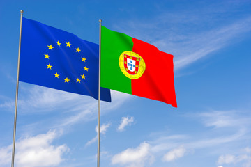 European Union and Portugal flags over blue sky background