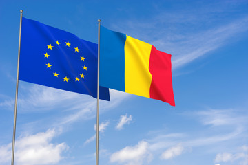 European Union and Romania flags over blue sky background.