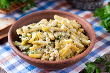 Cooked green beans in sour cream with greens in a plate