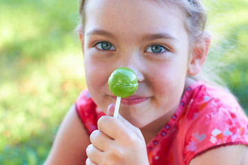 Little girl with a lollipop in her hand.