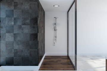 Black tile and glass bathroom interior, shower
