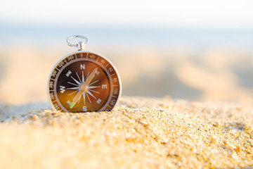 Compass on sand.