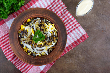 Spicy salad of fried eggplant, boiled egg, marinated onions in a bowl. Top view.