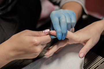 Obraz na płótnie Canvas Professional manicure process in beauty salon. Procedure for cleansing cuticles on nails. Instabeauty