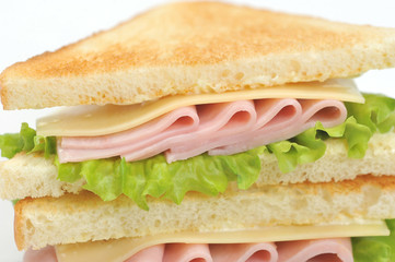 Sandwich with ham and cheese from white bread. The sandwich occupies the space of the frame. Close-up. Macro photography.