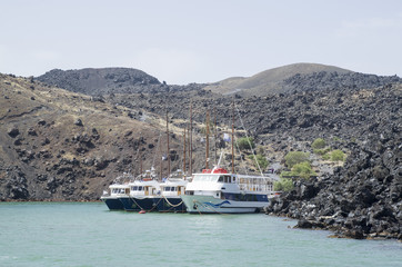 Wooden ships on port of Nea Kameni volcanic island near Santorini