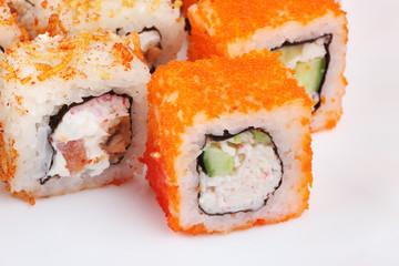 Sushi on a light background, close-up. With caviar of flying fish. Fresh colored sushi.