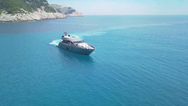 Amazing view to Yacht sailing in sea. Stock. Sunset view of the yacht. Luxury vacation on a yacht with friends in the sea