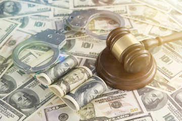 banknotes of American dollars, iron handcuffs for the detention of criminals, hammer of a judge....