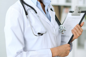 Doctor woman working at hospital.  Closeup of stethoscope. Health care, insurance and help concept
