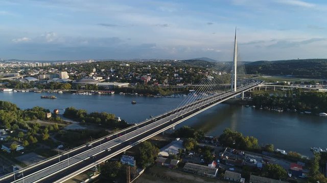 Drone shot of modern cable-stayed Ada Bridge spanning the Sava river in the suburbs of Belgrade, Serbia