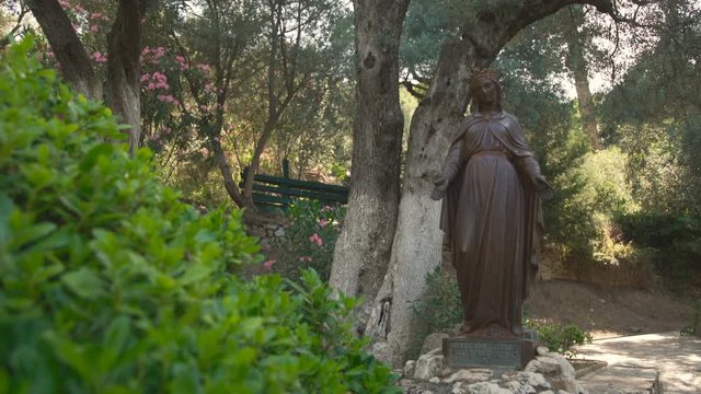 The statue of the Mother of God in a park. 4K