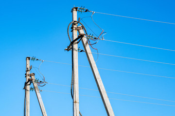 Electric bearing with wires on blue sky ground