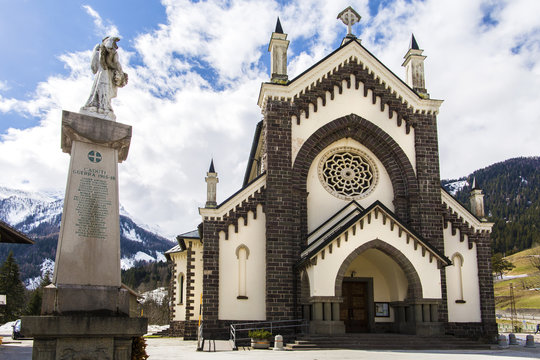 Falcade, Italy- 5 April 2018: The church of the Blessed Virgin Immaculate was founded on January 20, 1866. Falcade village, Belluno, Italy. Church of Falcade, Dolomites, Italy.