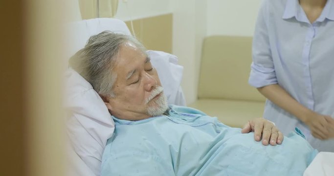 Beautifil asian women blankets for elderly patients who sleeping on bed in hospital.
