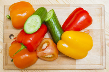 Healthy and Organic Food Concepts. Plenty of Fresh, Healthy and Appetizing Vegetables Placed on Wooden Surface Indoor.