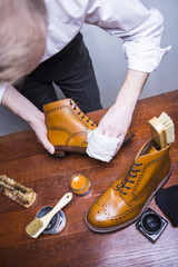 Footwear Ideas. Professional Male Shoes Cleaner Polishing Male Tan Brogue Derby Boots with Cream and Wax.