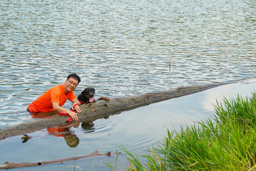 Man and dog playing in the lake