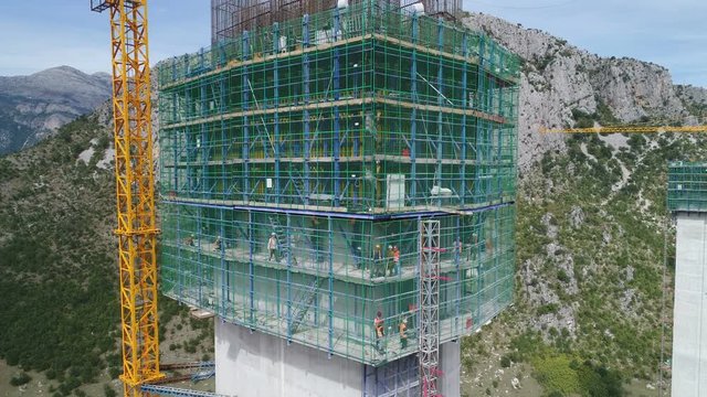 Drone shot of massive infrastructure project, Chinese government owned corporation building bridge and highway in Montenegro, political influence Europe