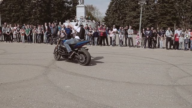 Motorcyclist masterly manages a motorcycle without hands. Slow motion playback
