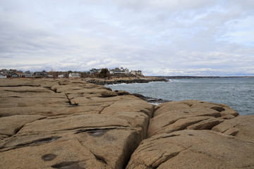 Rocky shore and vacation homes on coast near York, Maine