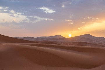 Fototapeta na wymiar Sunrise over the Dunes in the Sahara Desert in Morocco
