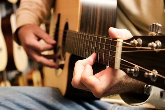 Male hands playing a guitar