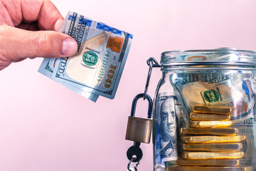 Close up of business man hand putting the bill dollars in his office in finance,investment,saving...